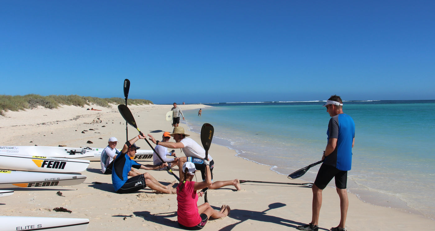 Paddlers on surf skis in clear ocean water